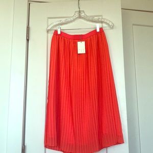 Coral pleated midi skirt